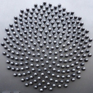 Metal-headed pins arranged in a spiral sequence