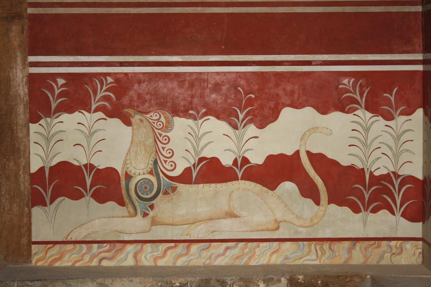 Minoan fresco depicting a reclining lion-like creature, detailed with vibrant colors against a red background.