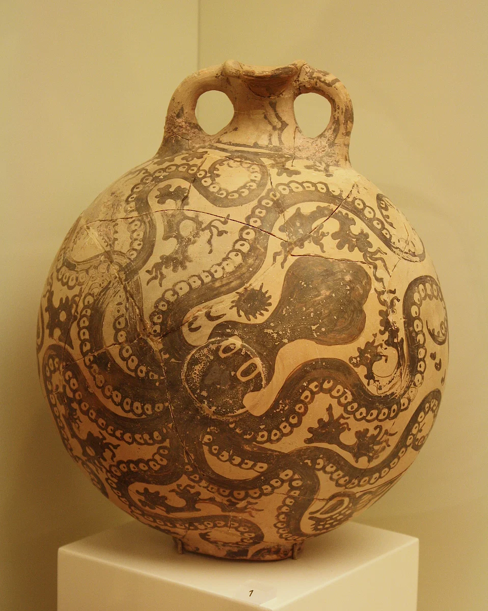 Ancient pottery vase with intricate octopus designs, featuring two handles and a round shape.