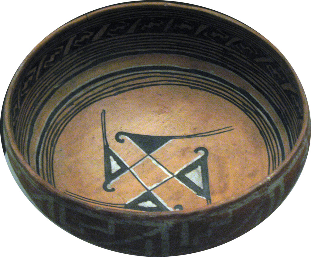 A 14th-century fired clay ancestral Hopi bowl from Navajo County, Arizona, is beautifully decorated with a geometric pattern along the rim and  stylized birds in a circle in the center of the bowl connected to a diamond shape.