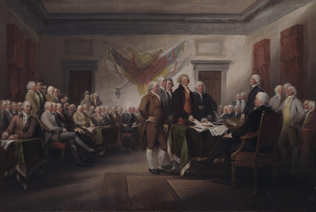 The five drafters of the Declaration of Independence present the document to four two other members of the Second Continental Congress inside the main chamber of Independence Hall. John Adams, Roger Sherman, Robert Livingston, Thomas Jefferson, and Benjamin Franklin stand in the center of the painting placing the draft of the Declaration of Independence on a desk in front of John Hancock, who is seated at the desk, and Charles Thomas, who is standing to Hancock&rsquo;s right. The room is filled with 35 additional signers of the Declaration of Independence&mdash;some standing, some seated&mdash;looking on at the action in the center of the painting. In the background, four different British flags are mounted on the wall directly above the drafters&rsquo; heads.
