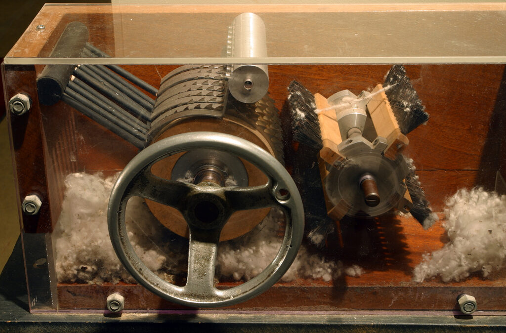 This is a photograph of a 19th-century cotton gin on display at the Eli Whitney Museum.