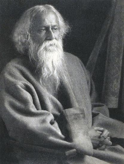 Rabindranath Tagore, with a long white beard, stares wistfully into the distance in a black and white photograph