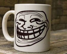 Coffee mug with a stretched-out smiling face on it