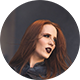 Round photo (like an email avatar) of a woman with long red hair and black lipstick