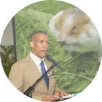 Round image (like an email avatar) of a man speaking. Projected behind him is a photo of a hamster