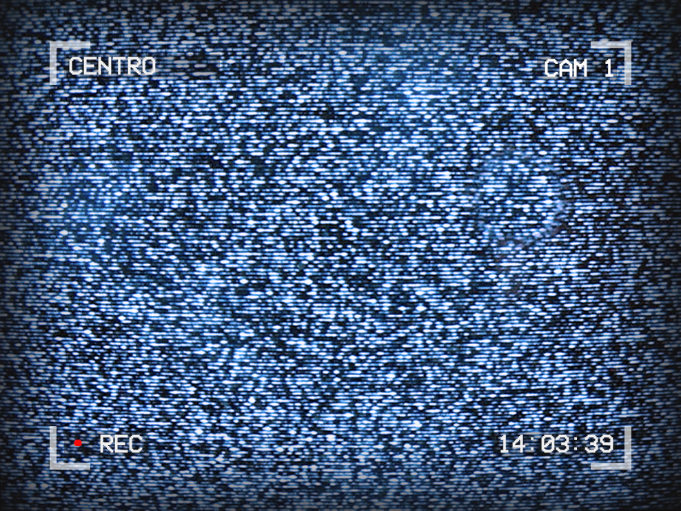 Image of TV static. Text around the outside reads: Centro, Cam 1, 14:03:39, Recording