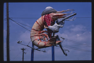 A sign depicting a giant cowboy shrimp.