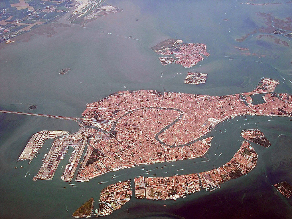 Bird's-eye-view of Venice; there is a road connecting the city on the water to the mainland of Italy.