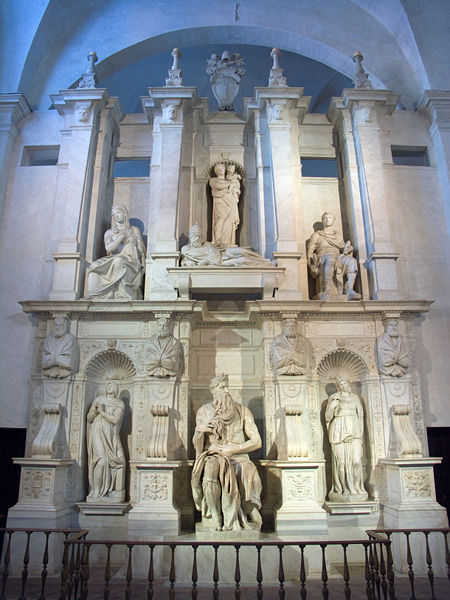 The completed face of the tomb. The structure includes 7 human sculptures on two different levels. The upper level has the Madonna and child at its center with a statue on either side of them, and another at their feet. The lower level has Moses at its center with two other figures carved standing in alcoves.