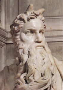 A close up of Moses's face. This picture focuses on his expression. His mouth is almost pulled into a frown, and his eyes are clearly focused on something the viewer doesn't know about.