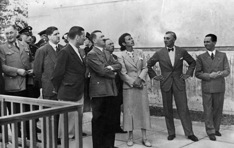 Photograph of Adolf Hitler and several other individuals standing outside the House of German Art.