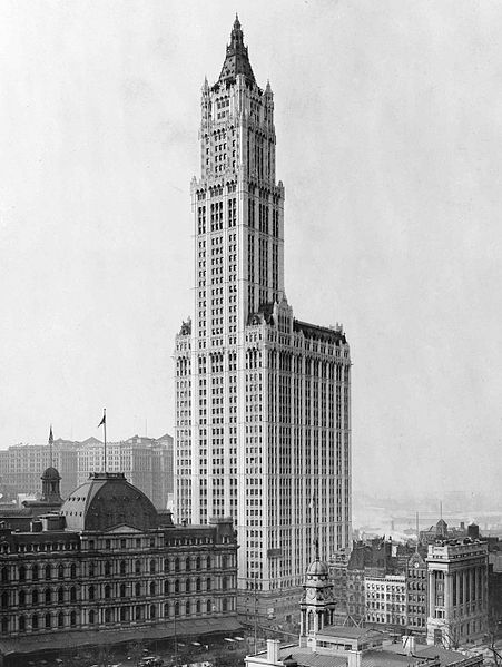 The Woolworth building rises into the sky, easily twice if not three times as high as all of the other buildings around it.