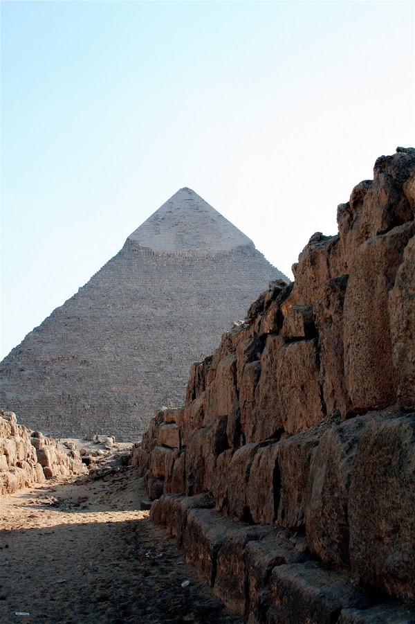 A view of the pyramid from a walled path.