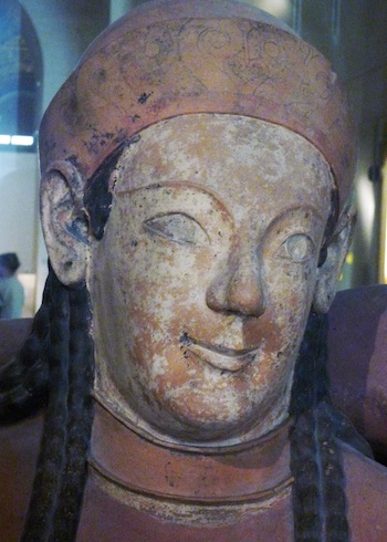 Close up of the woman's face in this carving. Her face has been painted white.