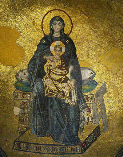 Mary and Christ sit on a throne with no back, which is topped with two pillows. Both Mary and Christ have halos, though Christ's halo is white and gold, while Mary's is just gold.