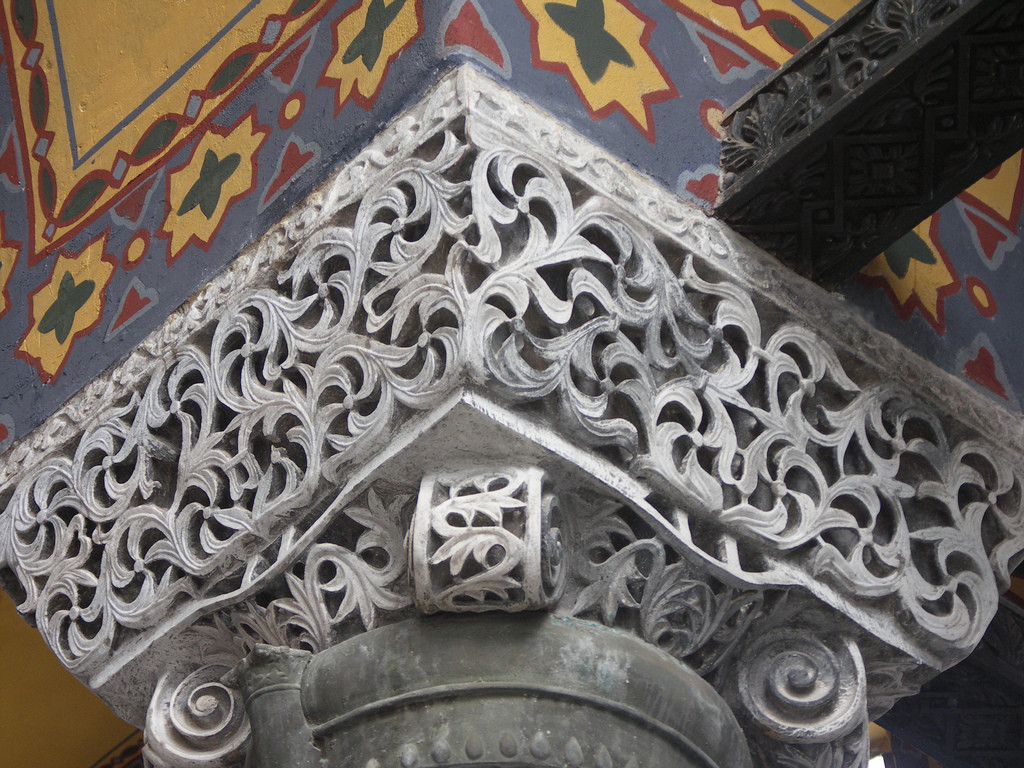 This basket capital appears to be mostly hollow with cut aways from the exterior to reveal this. The carving appears to be a representation of vines and leaves.