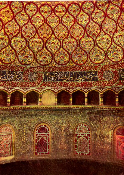 The interior is painted with reds and golds creating a very intricate pattern. There are arabic words along the bottom of the dome.