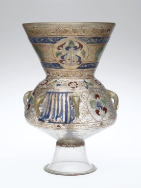 The lamp has a clear glass bottom and the top portion is opaque. This portion has geometric designs; the detail on the lamp is not as detailed as has been seen on walls.