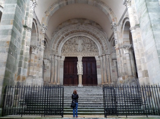 The majority of the cathedral's exterior is plain stone, but there is an intricate Figure carved over the entrance, as well as one in between the two doors of the portal.