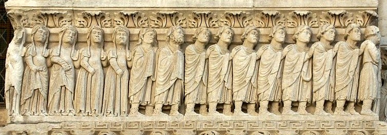 A row of individuals each with their hand on the shoulder of the person in front of them.