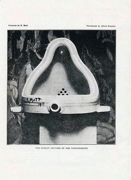 Photograph depicting a porcelain urinal, which is signed "R.Mutt" in black script.