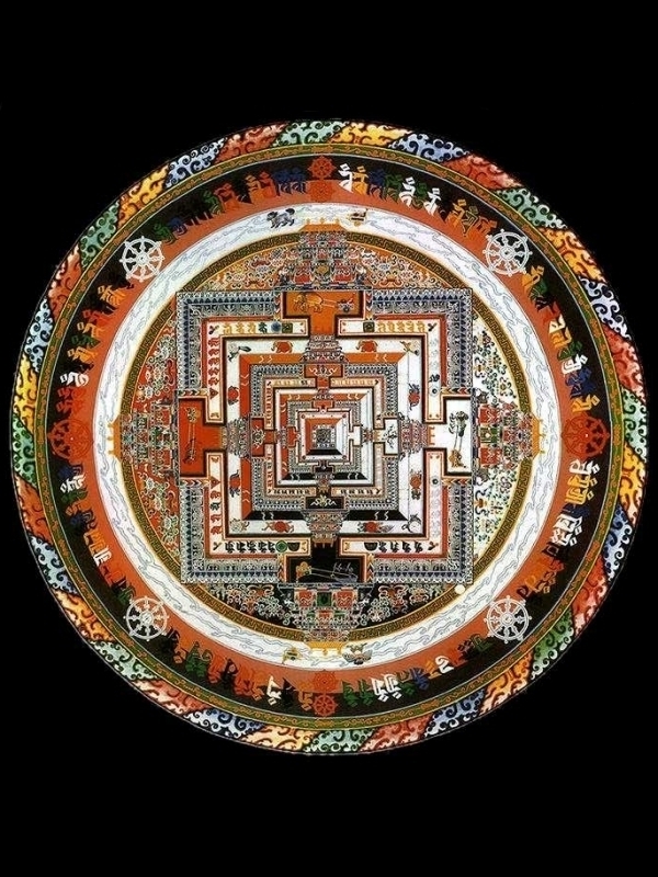Depiction of a sand mandala, a circle with an ornate geometric pattern inside of it. The pattern is made from colored sand.