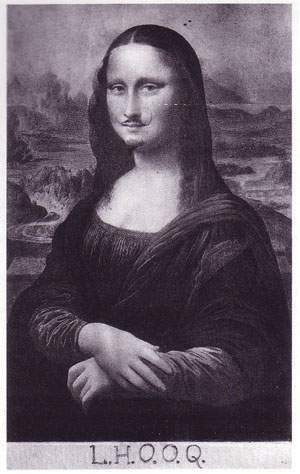 Black and white postcard reproduction of the famous Italian Renaissance portrait The Mona Lisa. A mustache has been drawn on the subject's upper lip. The letters LHOOQ are hand-written along the bottom of the card.