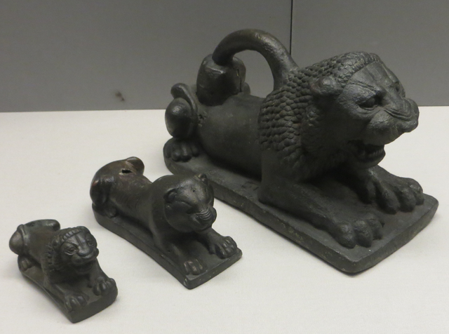 Photograph of three bronze lion weights: small, medium, and large.