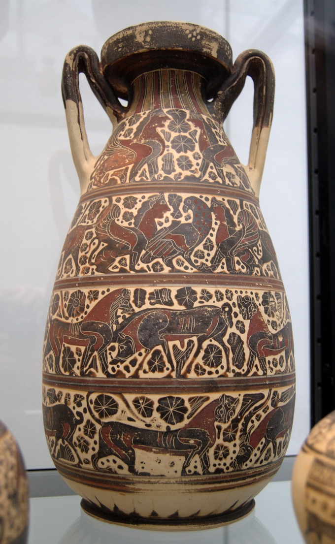 Color photograph of a jug with rows of black figures depicting animals, such as birds and horses.