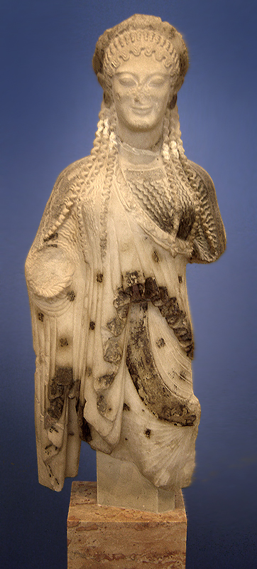 This is a photo of the Acropolis Kore statue, which depicts a woman wearing a one-shouldered draped garment and a draped cloak.