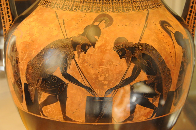 This is a photo of pottery decorated with a scene of Achilles and Ajax playing a game in their war armor.