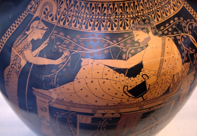 This is a color photo of pottery decorated with a scene depicting Herakles and Athena in the red figure style.