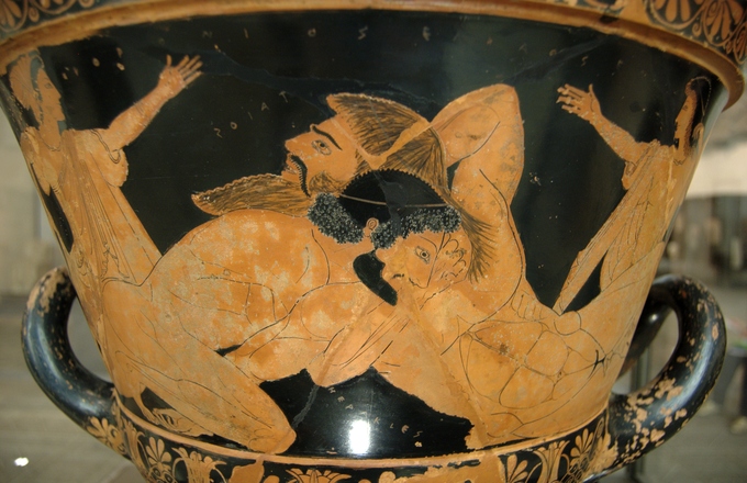 This is a photo of Herakles Wrestling Antaios. It is a piece of Greek pottery depicting a wrestling contest between Herakles and Antaios.