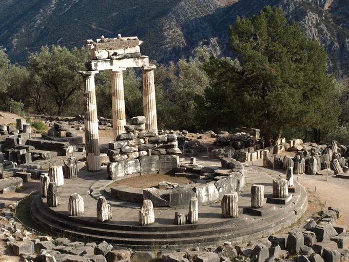 This is a photo of the ruins of the Tholos of Athena Pronaia at Delphi. It shows the unique circular shape of the building's foundation as well as the twenty Doric columns supporting frieze with triglyphs and metope.