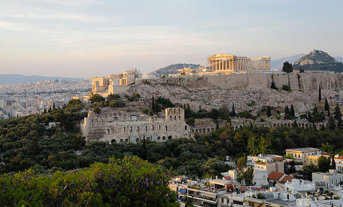 A current-day color photo of the ruins of the Acropolis at Athens. It shows the ancient citadel located on an extremely rocky outcrop above the city of Athens, containing the remains of several ancient buildings of great architectural and historic significance, the most famous being the Parthenon.