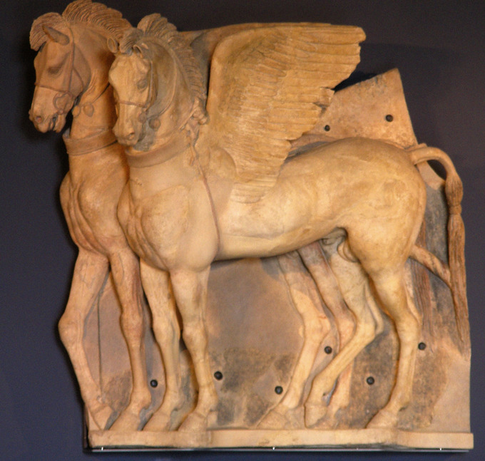 This is a photo of the terra cotta statue Winged Horses, which features two detailed winged horses standing side by side.