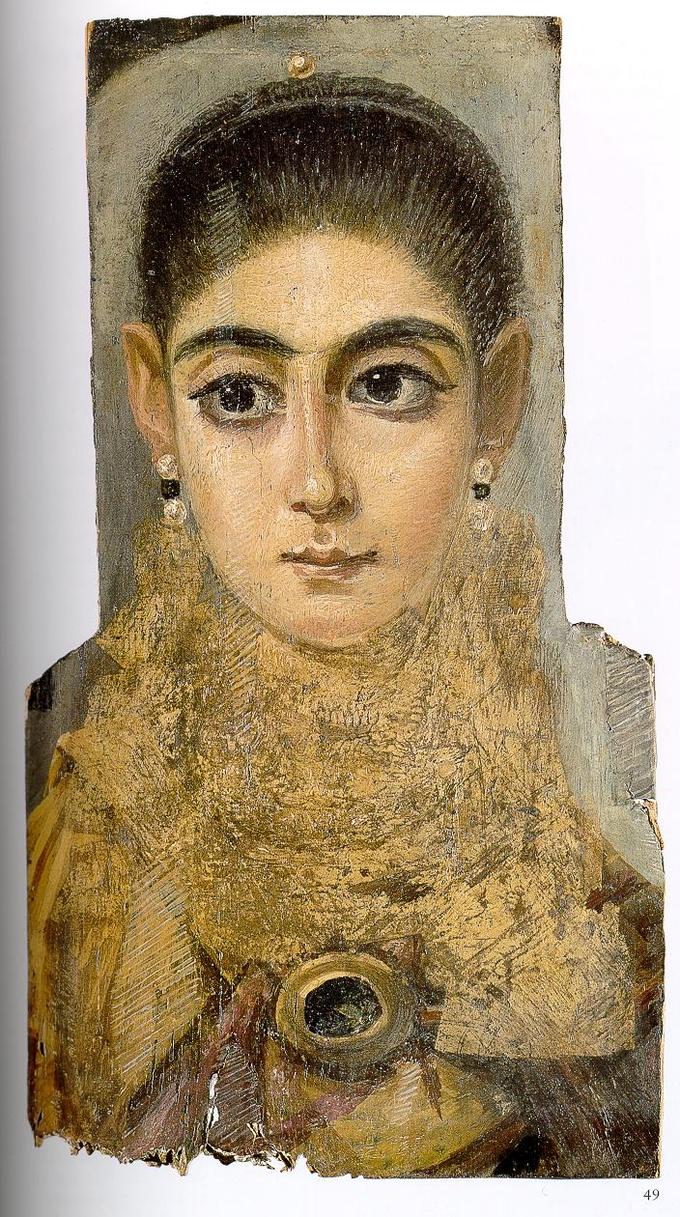 This photo shows a mummy portrait of a young woman. She has dark hair pulled back from her face, prominent dark eyebrows, and large defined eyes. Her nose is narrow and thin and her lips are small in proportion to her face. She wears earrings and a high gold-colored collar.