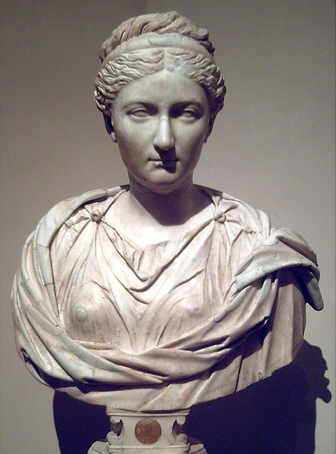 This photo shows a bust of Vibia Sabina wearing her hair in a braided updo, a Greek hairstyle.