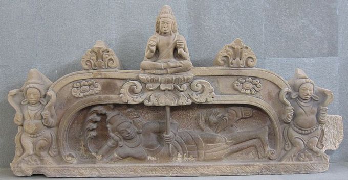 This photo shows a sculpture of the birth of Brahma. This unfinished pediment is a fine example of Hindu art in the style of Champa. The relief sculpture shows the birth of the Hindu god Brahma from a lotus growing from the navel of Vishnu.