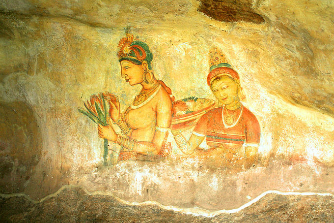 This is a photo of a Sigiriya fresco. The frescoes at Sigiriya depict graceful female figures bearing flowers, such as this one.