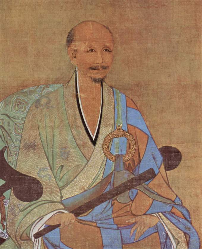 The monk is depicted sitting, in colorful clothing, with a peaceful expression.