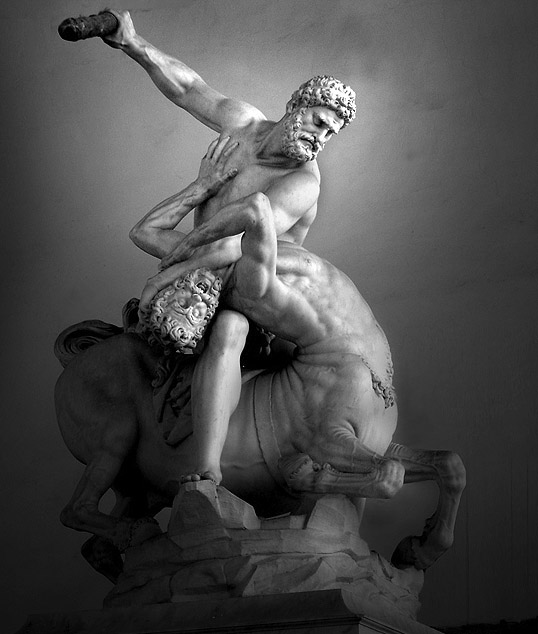 Sculpture depicts Hercules on top of the centaur Nessus, holding the centaur’s head down. Hercules extends his right arm back, holding an object that he is using to beat Nessus.