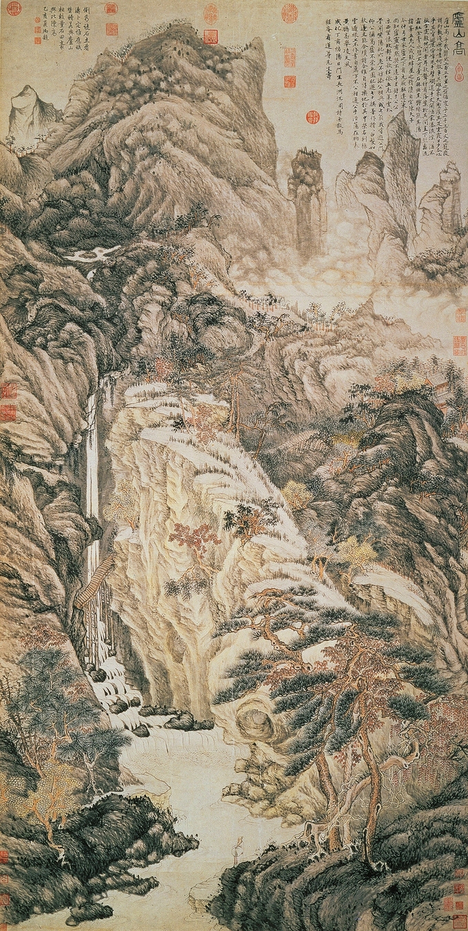 Landscape with a tall waterfall in the foreground and a mountain in the background.