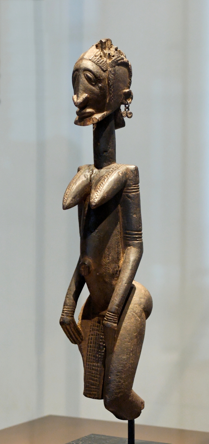 This figure has an elongated neck, breasts, and torso.