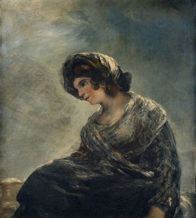 La pintura representa a una mujer vestida con ropa oscura y un pañuelo en la cabeza sentada y mirando hacia abajo.