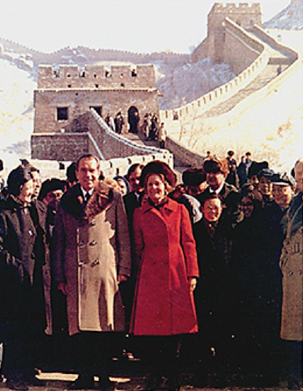 A photograph shows Richard Nixon, Patricia Nixon, and a host of officials standing in front of the Great Wall of China.