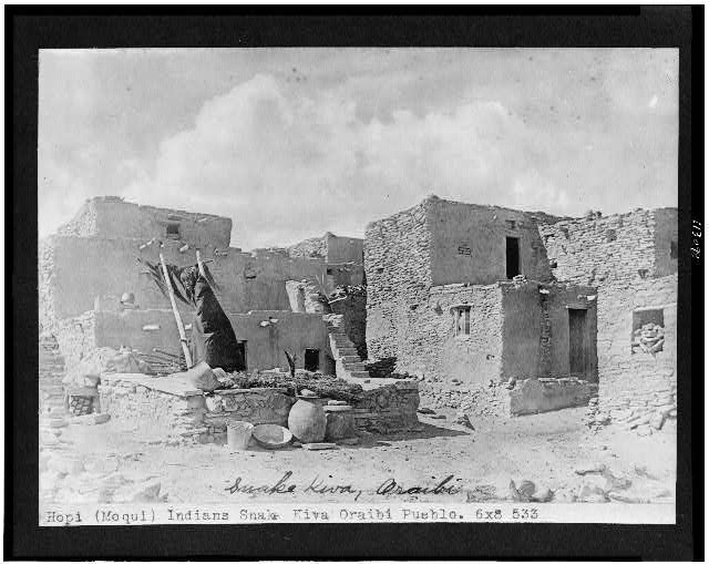 Old photo of Hopi Indian dwellings built into rocks