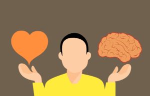 A cartoon person with a heart in one hand and a brain in the other.