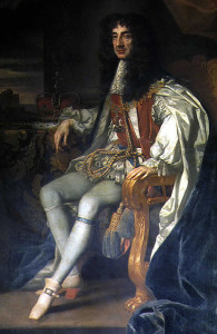 Oil painting of Charles II. He is sitting at an angle to the viewer, turned to face the viewer straight on. His hair is chest-length black curls. His crown rests on a table beside him.